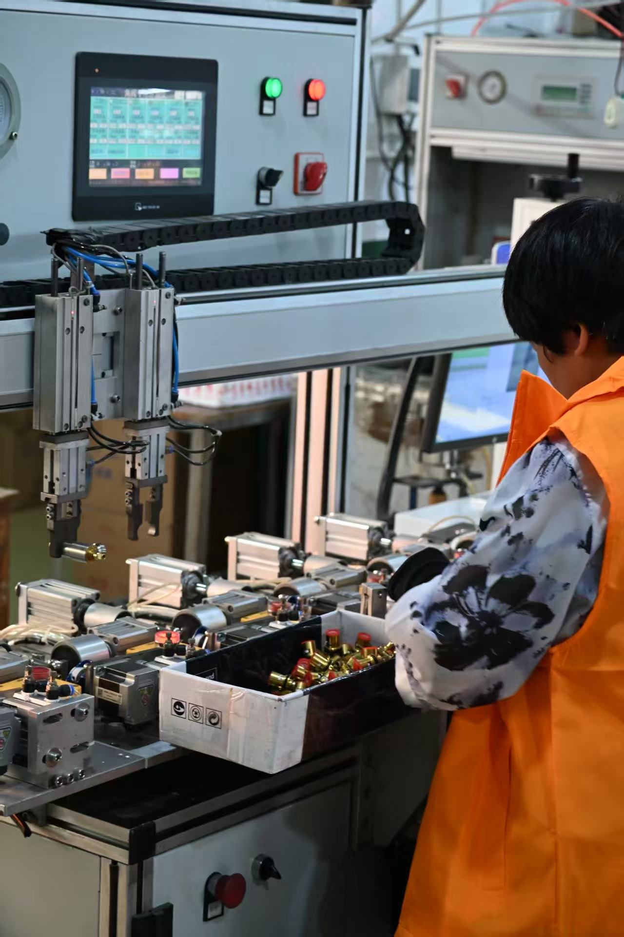 Worker beside product fixtures and production equipment